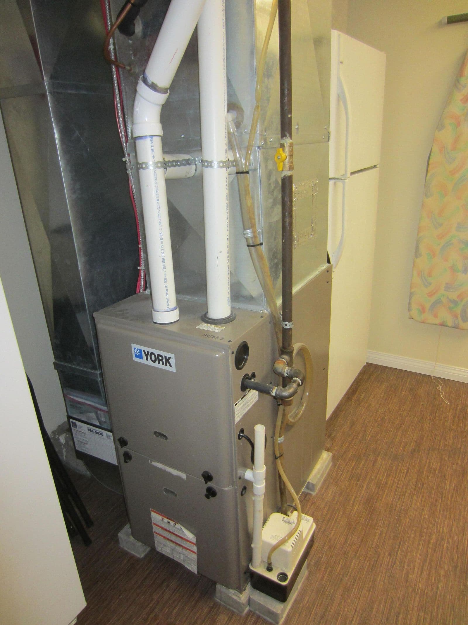 A residential gas furnace in a utility space