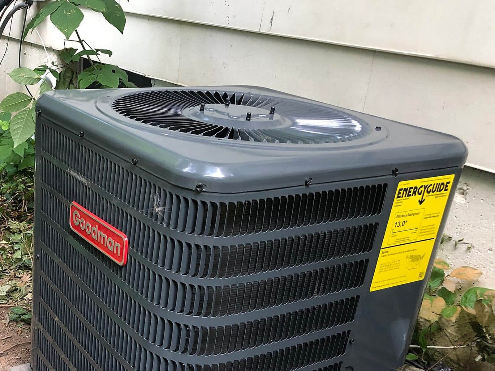 An outdoor air conditioning unit beside a home